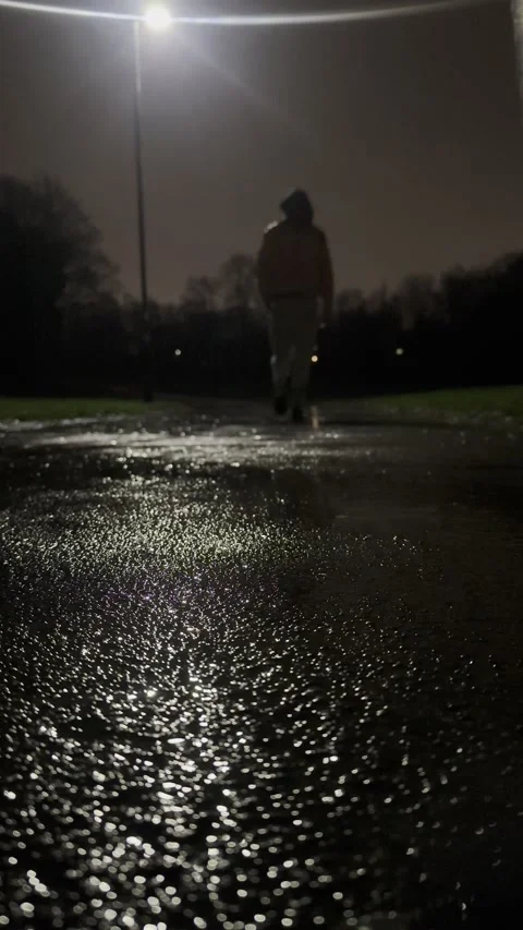 Man walking in rain alone night 05.mp4 Stock Footage 326588479