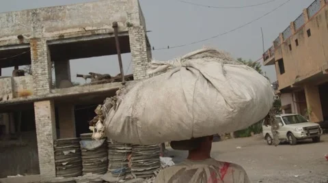A man walking with recyclable papers Video stock 66043966