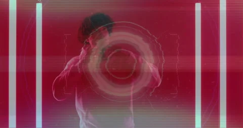 Man walking into red-lit space with LED tubes activating tech circles adjusting 動画素材 315503701