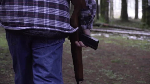 Man walking with rifle Stock Footage 61245443