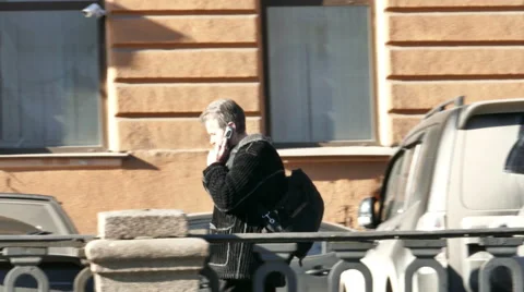 Man Walking at River Quay While Talking the Phone in St. Petersburg, Russia Stock Footage 56162015