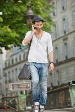 Man walking on the road and talking on a mobile phone, Paris, Ile-de-France, Foto stock