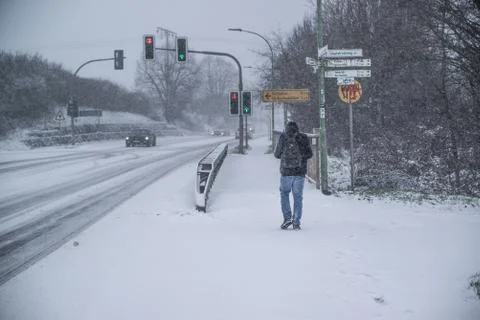 A man walking on a road in heavy snow , Germany, Hesse 2017 Stock Photos