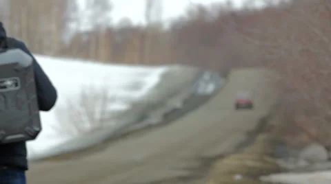 Man walking on the roadside with drone case. Stock Footage 61684409