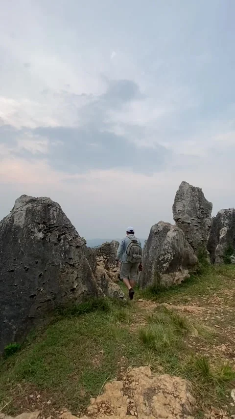 Man walking on rocks Stock Footage 241818627