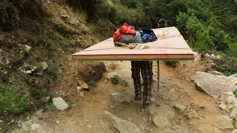 Man walking on a rocky road with a huge Stock Video Pond5