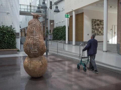 Man walking with rulator inside oslo university hospital rikshospitalet Stock Photos