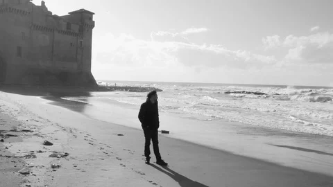 Man walking sad in front of the ocean Stock Footage 107087644