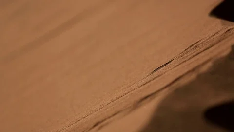 A man walking in the sand, sand slides down the mountain at sunset, close-up Video stock 76433536