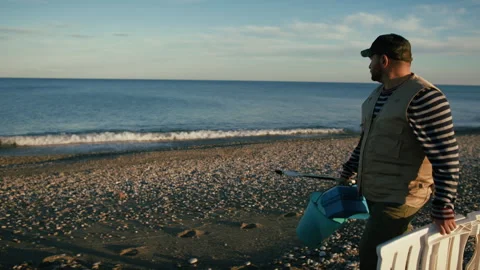 Man Walking In The Sand Searching For A Spot To Fish Stock Footage 310682210