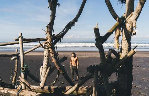 Man walking on sandy beach Stock Photos