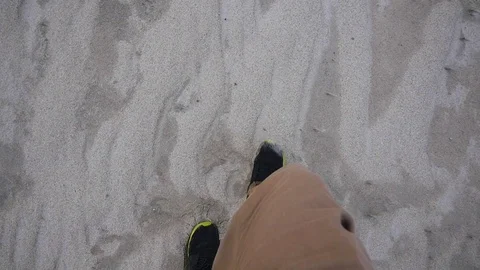 Man walking on sandy beach in slow motion Stock Footage 71565948