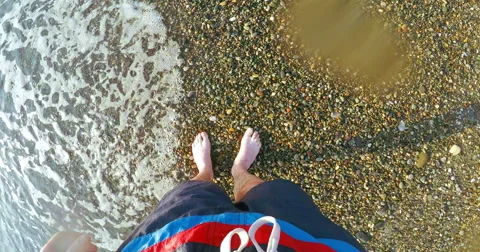 Man walking on sandy beach with waves crashing Stock-Footage 62466604