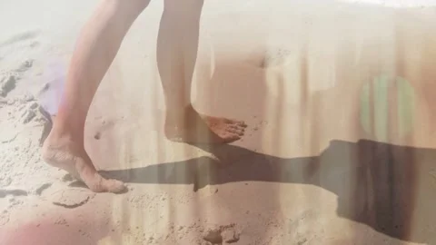 Man walking sandy shore, bare foot landing starting walk, lightleaks tracing Video stock 332625581