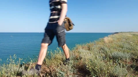 Man walking on the sea cliff Stock Footage 61912036
