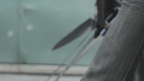 Man walking with several knives in his hands Stock Footage 289071997