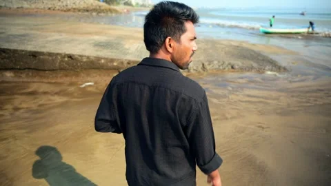 Man Walking by the Shoreline Stock Footage 281321865