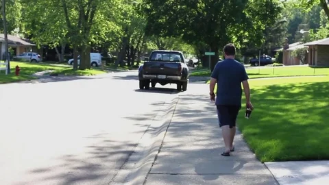 Man Walking on Sidewalk in Suburbs 1080p Stock Footage