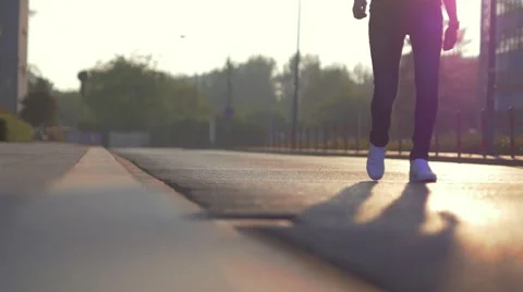 Man walking on the sidewalk. Sunset time. Stock Footage 63555420