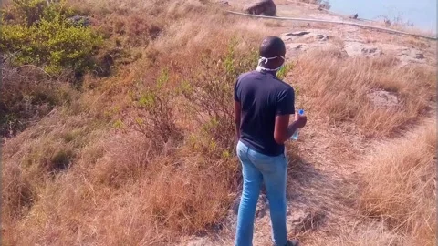 Man Walking to a Small Lake Stock Footage 136988460