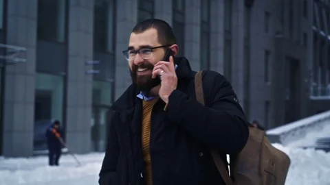 Man walking smiling and talking on phone on business street Stock Footage 71981562