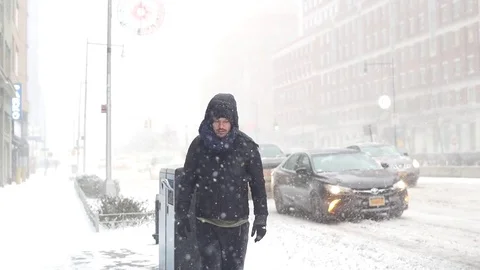 Man Walking on Snow in Brooklyn during snowstorm Manhattan New York City usa Stock Footage 84740343