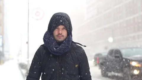 Man Walking on Snow in Brooklyn during snowstorm Manhattan New York City usa Stock Footage 84740374