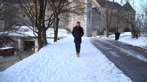 A man walking on snow in cold winter heating his hands with his breath Stock Footage 101829020