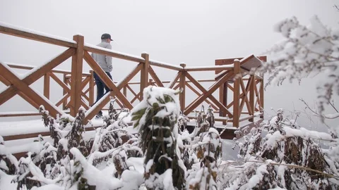 Man Walking on Snow Covered Viewpoint Overlooking the Town of Bajina Basta, Stock-Footage 90074905