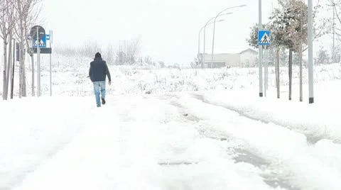 Man walking on the snow Stock Footage 10739073