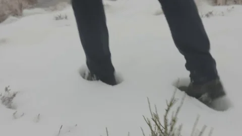 Man walking in snow Stock Footage 72755781