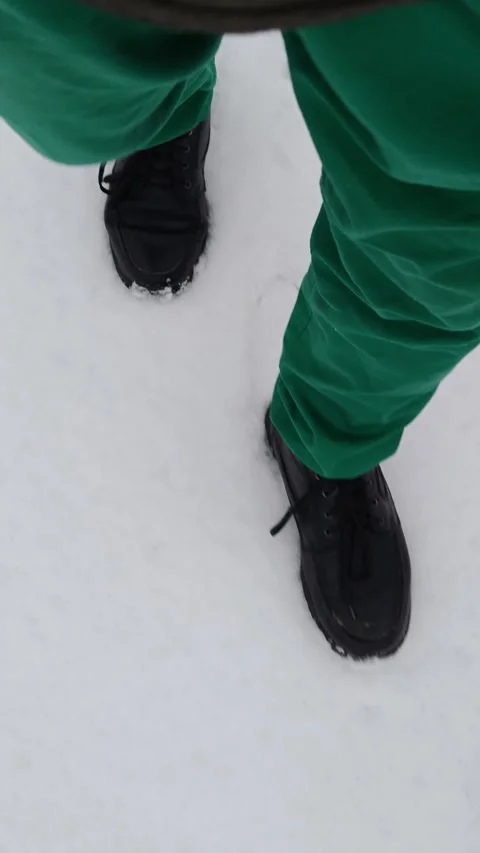 A man walking in the snow, view from above 스톡 동영상 323620029
