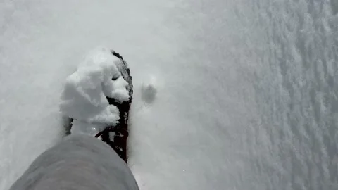 Man walking on snow in winter, leaving footprints on fresh snow. View from eyes. Stock Footage 172575431