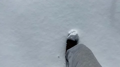 Man walking on snow in winter, leaving footprints on fresh snow. View from eyes. Stock Footage 172575667