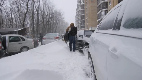 Man Walking in a Snowstorm Stock Footage 98188225
