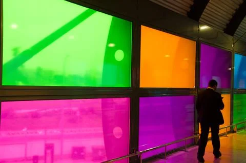 Man walking by stained glass windows. Stock Photos