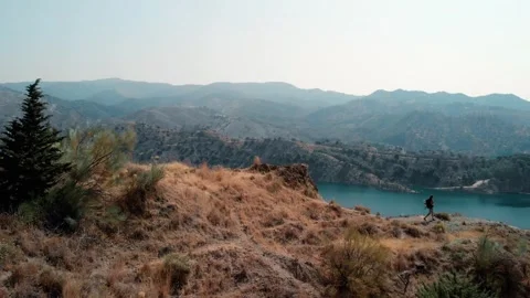 Man walking steadily along a ridge, embracing solitude and freedom, while e.. Stock Footage 344051912