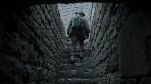 Man walking up stone stairs in a medieval Castle Stock Footage 128667867