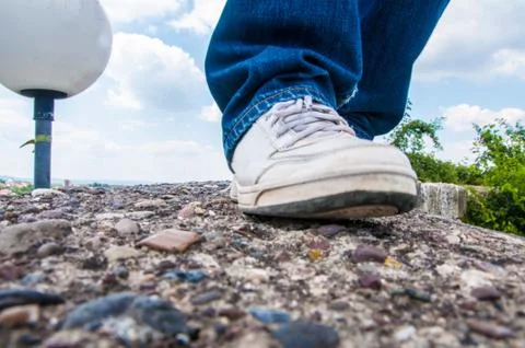 Man walking on the stone wall Stock Photos
