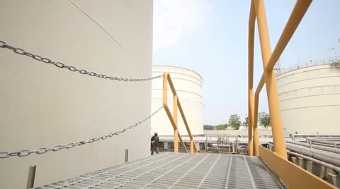 Man walking in storage tank area 库存影片 37872993