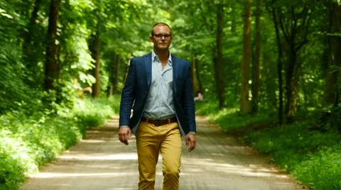 Man walking straight forward. facing camera. young male. business lifestyle Video stock 64800959