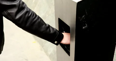 Man walking on the street and throwing garbage in trash bin. Stock Footage 221904651