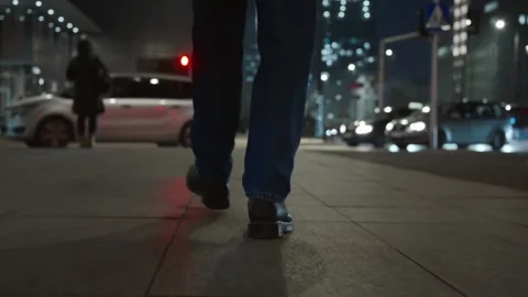 Man Walking Street at Night Close Up Boots Backlit Lights Stockbeeldmateriaal 334562913