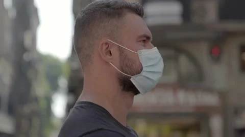 Man walking on the street with protective face mask on Stock Footage