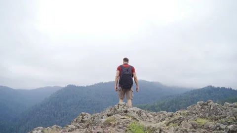 The man walking on the summit.  Feeling of freedom. Stock Footage 212259468