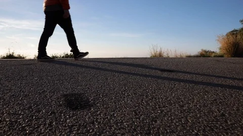 Man walking at sunrise Stock Footage 104123643