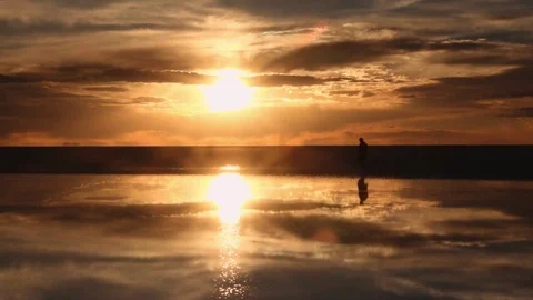 Man walking on sunset reflection Stock Footage 80902969
