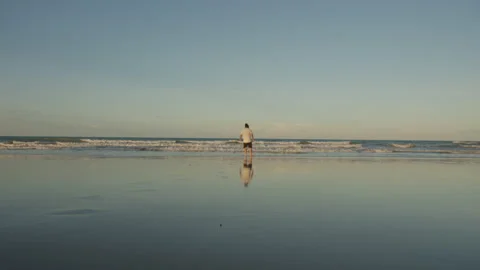 Man walking in sunset walter mirror Stock Footage 199710004