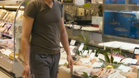 A man walking in a supermarket Stock-Footage 80169273
