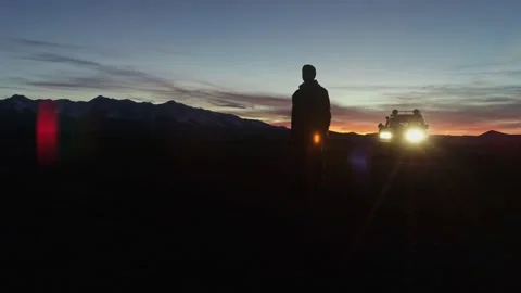 A man walking from an SUV with a beautiful view of the mountains. A young man Stock Footage 245555533